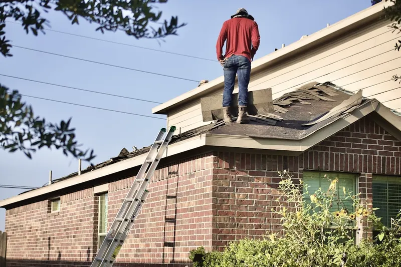 Professional roofer working on a residential roof in Westfork